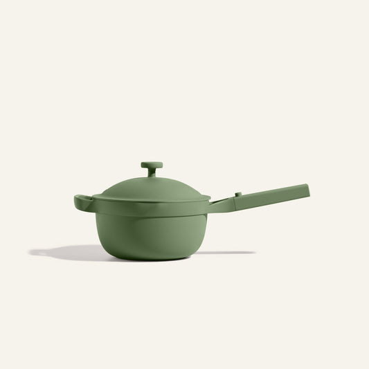 The Mini Perfect Pot 2.0, a matte green nonstick pot with a lid and long handle, is set against a plain light background.