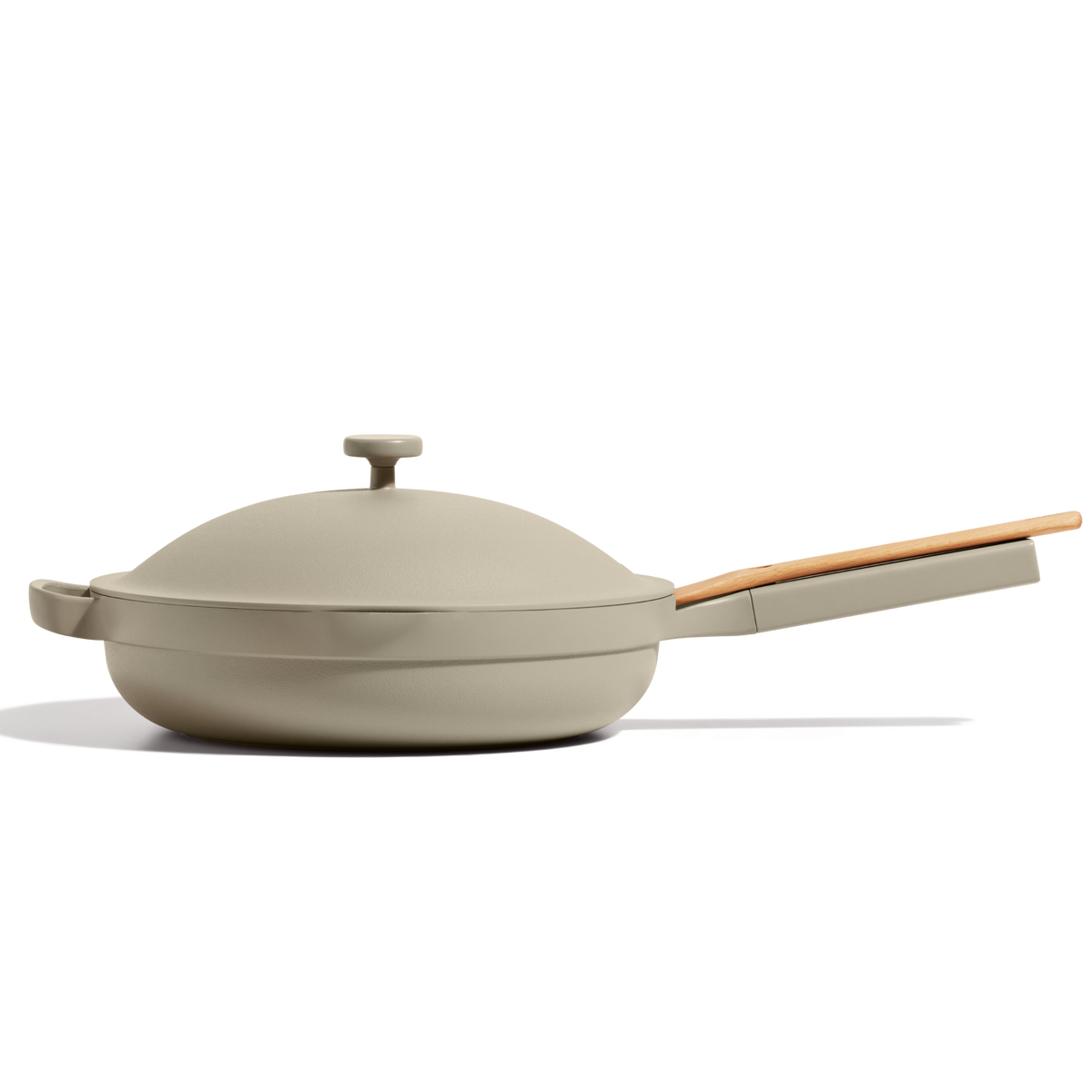 The Large Always Pan in beige, a 10-in-1 nonstick pan with a lid and wooden handle, is shown in profile against a white background.
