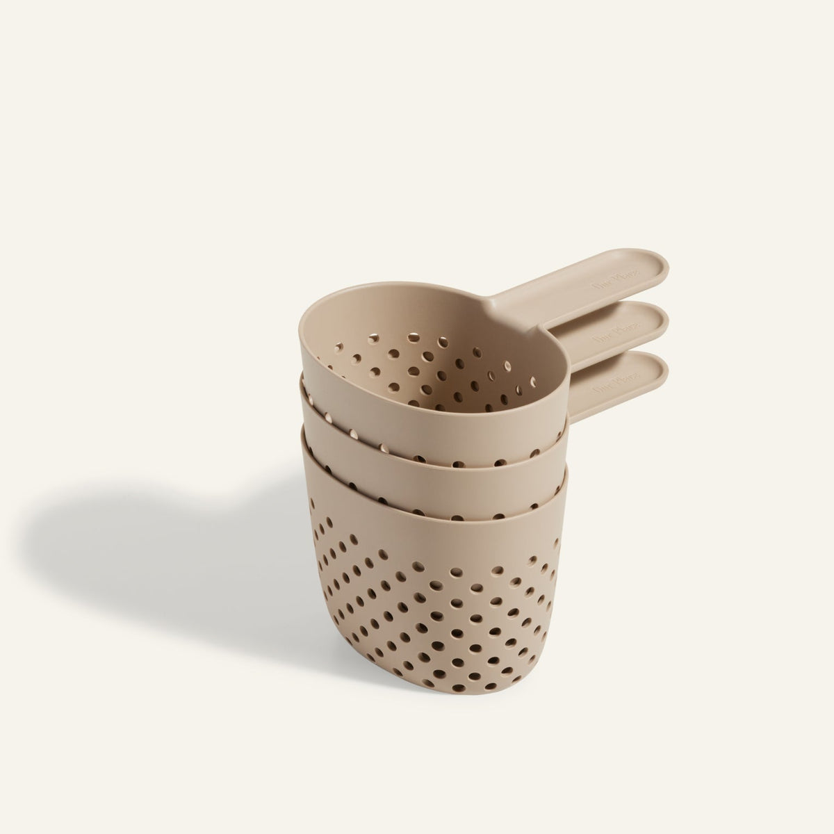 Three beige Cooker Cups, ideal for use with the Perfect Pot and multi-cooking, are stacked together on a light background.