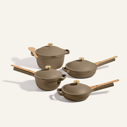 The Cookware Set includes four brown nonstick pieces with wooden handles and gold knobs: a frying pan, sauté pan, saucepan, and Dutch oven—ideal for complementing your 13-piece set or pairing with the Always Pan.