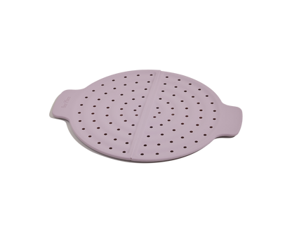 The Fearless Fry is a round, light purple silicone steamer basket with two handles and evenly spaced holes, designed to prevent splatter when used with the Always Pan. Displayed on a white background.