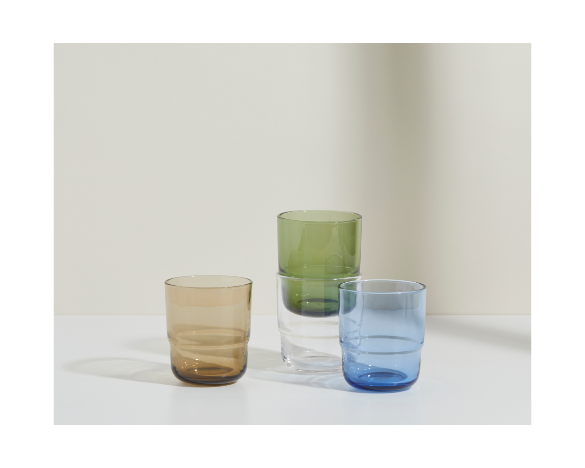 The Short Night + Day Glasses set features four handmade tumblers—brown, clear, green, and blue—crafted from recycled glass for a stylish, sustainable accent to any space.