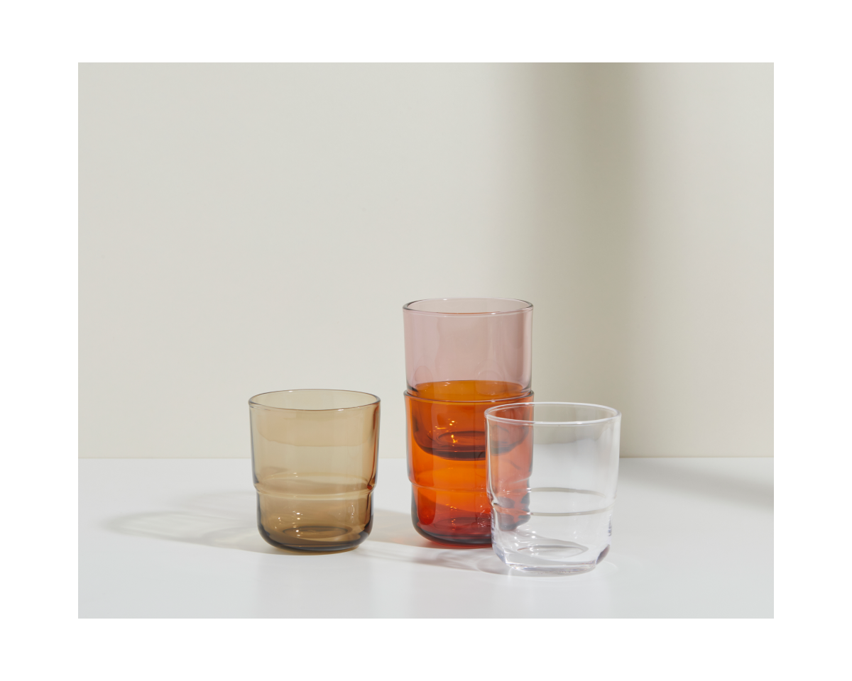 The Short Night + Day Glasses—brown, pink, and clear—crafted from recycled glass tumblers, are arranged on a white surface against a neutral background.