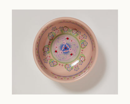 The Rice Bowl Set features round ceramic bowls with a light pink base, floral patterns, and a blue, purple, and red geometric motif—ideal tableware for your Lunar New Year celebrations.