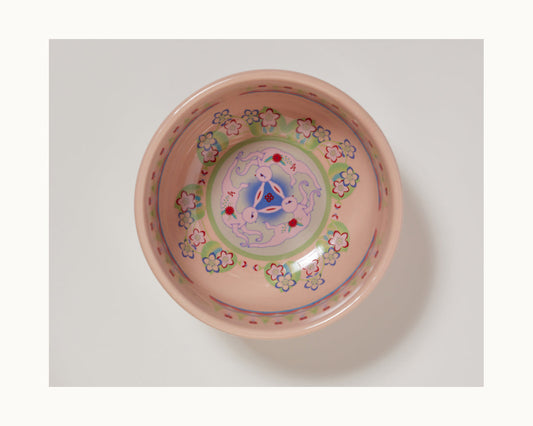 The Rice Bowl Set features round ceramic bowls with a light pink base, floral patterns, and a blue, purple, and red geometric motif—ideal tableware for your Lunar New Year celebrations.