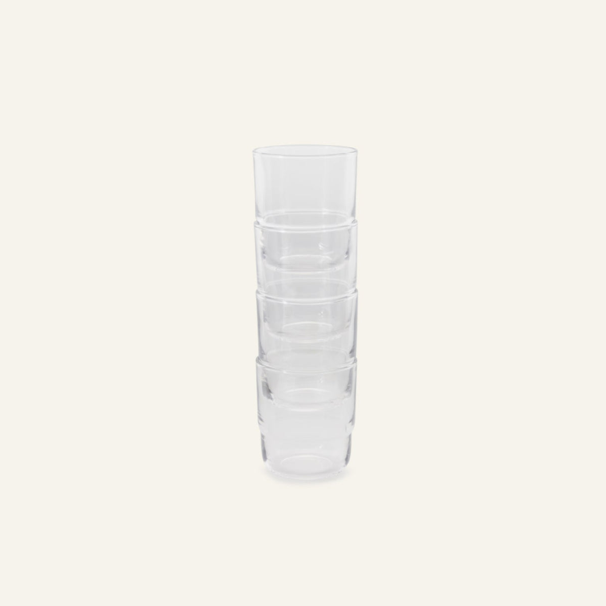 Four Short Night + Day Glasses, handmade from recycled glass, are stacked vertically against a plain, light background.