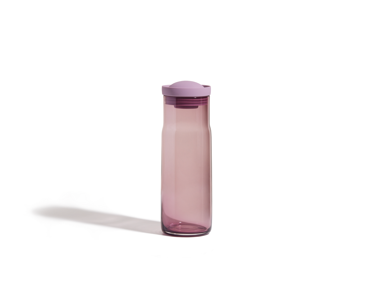 The Night + Day Carafe is a tall, translucent pink water bottle with a matching pink screw-on lid, ideal for pairing with your carafe or cold brew infuser for refreshing drinks wherever you go.