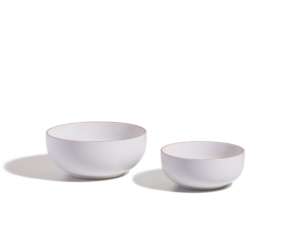 Two white Serving Bowls, one large and one small, with gold rims are shown on a white background with shadows—ideal as elegant, stackable tableware for serving salads.