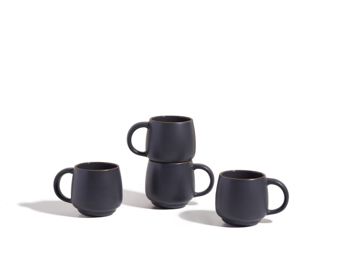 Four Night + Day Mugs in matte black ceramic stoneware, stacked in pairs on a white background—these stackable mugs offer a generous capacity, making them perfect for your favorite drinks.
