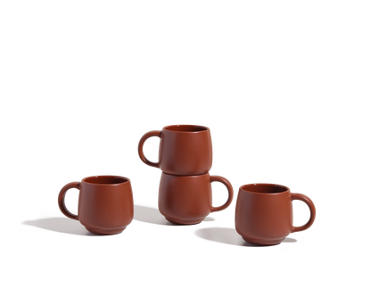Four Night + Day Mugs are displayed on a white surface: two are stacked, while the other two stand apart, highlighting their ample capacity and modern ceramic stoneware design.