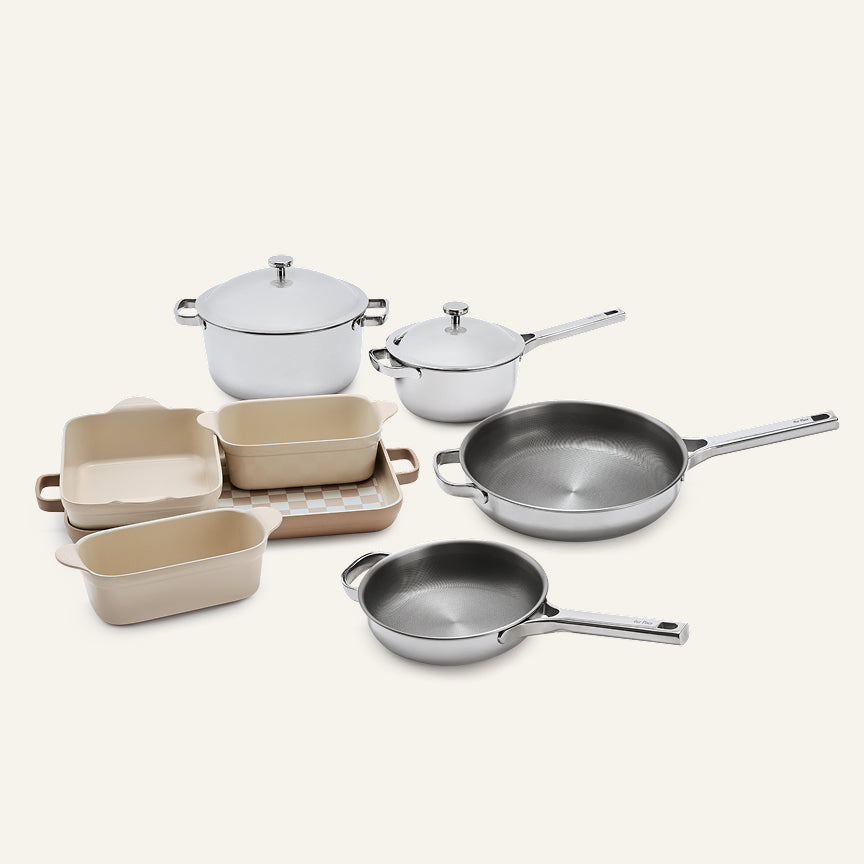 Titanium Pro Cookware + Bakeware Set 2.0 featuring high-performance stainless steel pots and pans with lids, and rectangular beige ceramic bakeware.