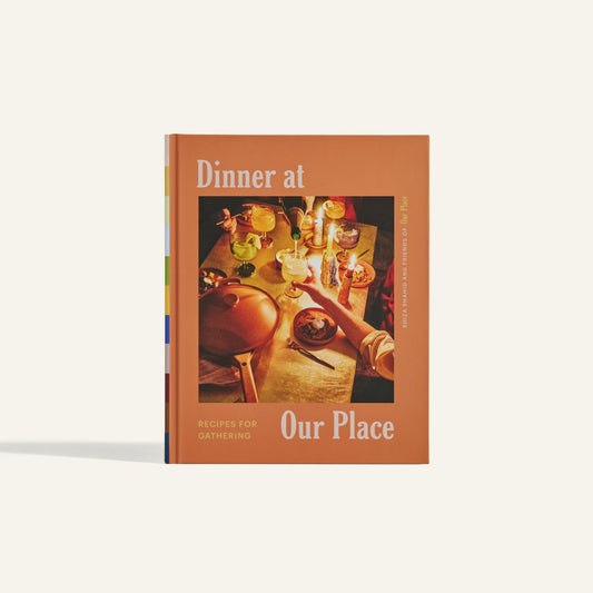 Dinner at Our Place is a cookbook by Shiza Shahid, featuring recipes for gatherings and an inviting cover with a meal table setting.