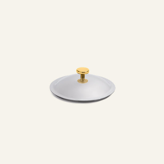 A round, stainless steel Titanium Pro Lid (Mini) with a small gold-toned handle.