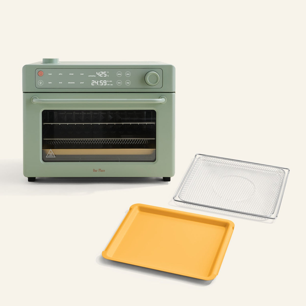 The Wonder Oven Pro + Wonder Oven Pro Essentials Kit features a green countertop oven with a digital display, shown with a yellow baking tray and silver wire rack in front.