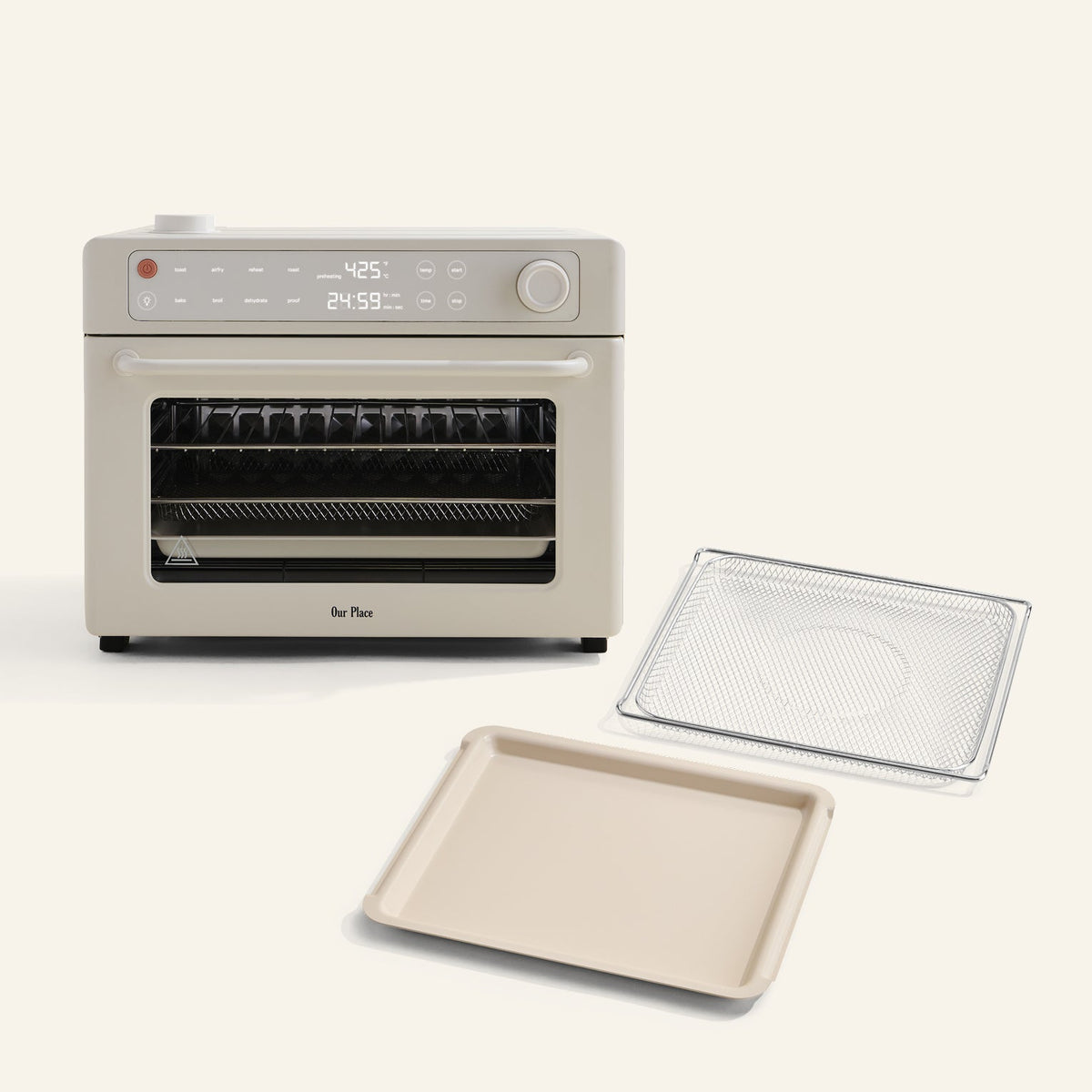 The Wonder Oven Pro + Wonder Oven Pro Essentials Kit, in beige with a digital display, is displayed on a light background alongside its wire rack and baking tray.