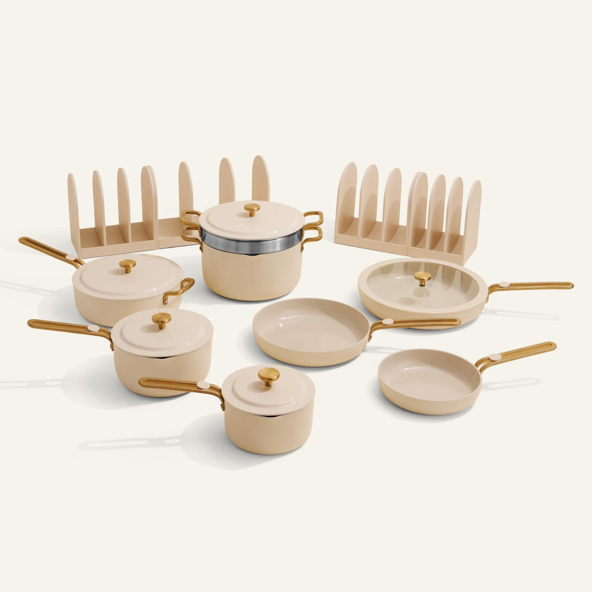 Set of ceramic cookware with gold handles on a white background