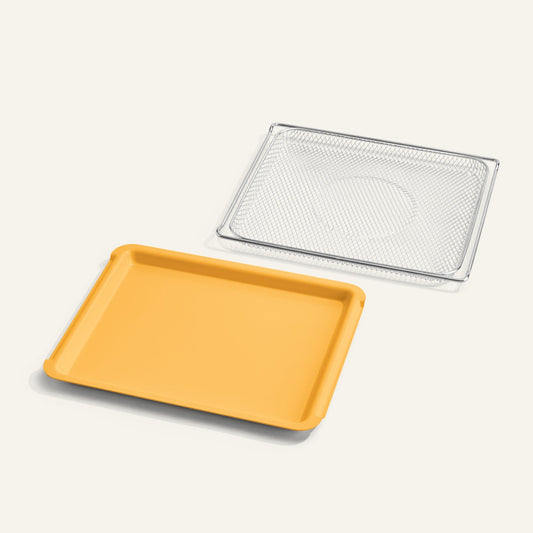 Yellow tray and silver mesh rack on a light gray background