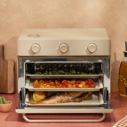 cooking vegetables, and fish on three trays in beige large wonder oven non toxic air fryer toaster oven on counter